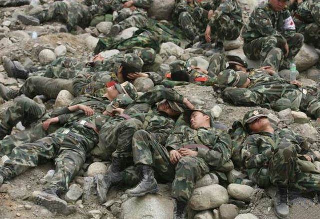 汶川地震期间 两天没睡觉的救灾军人在石堆上面就睡着了