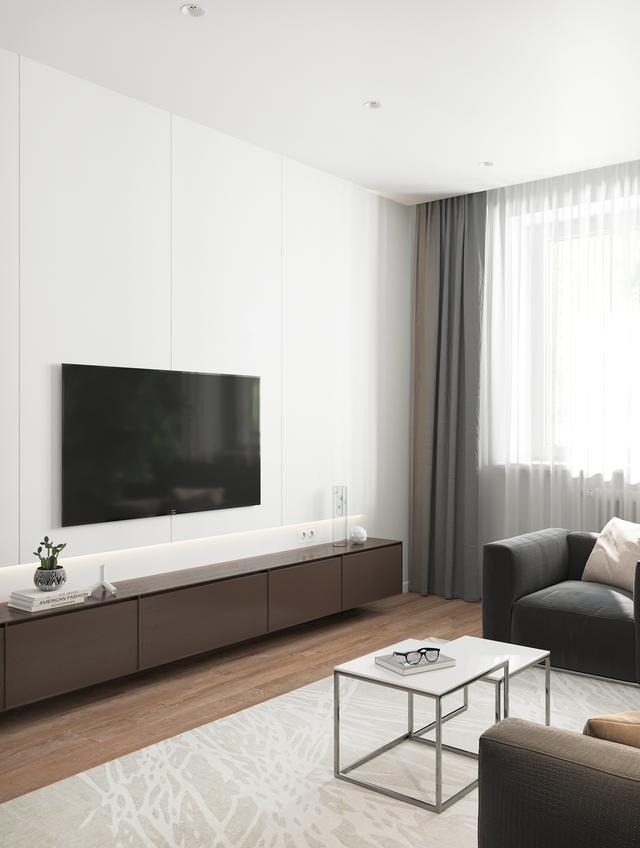 客厅做了一面白色的电视背景墙,电视机直接挂在墙面上;底下是一个长条