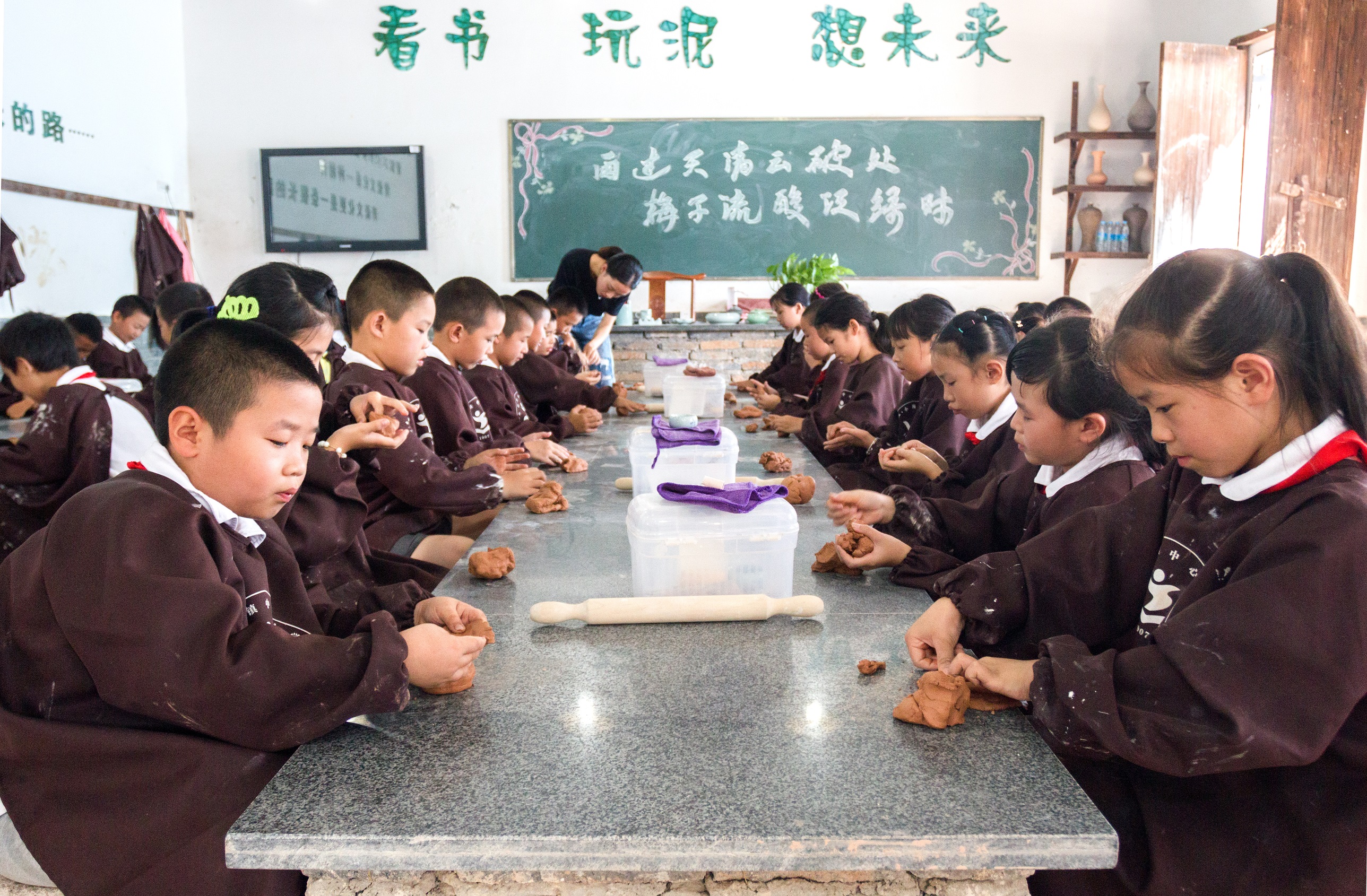 龙泉市小梅小学三(1)班学生在上陶艺课绿谷教育集团,实验小学教育