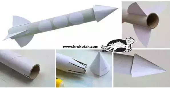 纸筒用白纸围绕,粘贴上机翼和火箭头