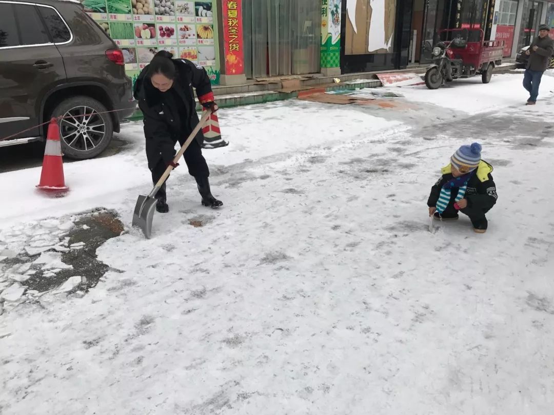 1月28日,石门县公安局组织民警上街扫雪,一个小男孩主动拿起小铲子