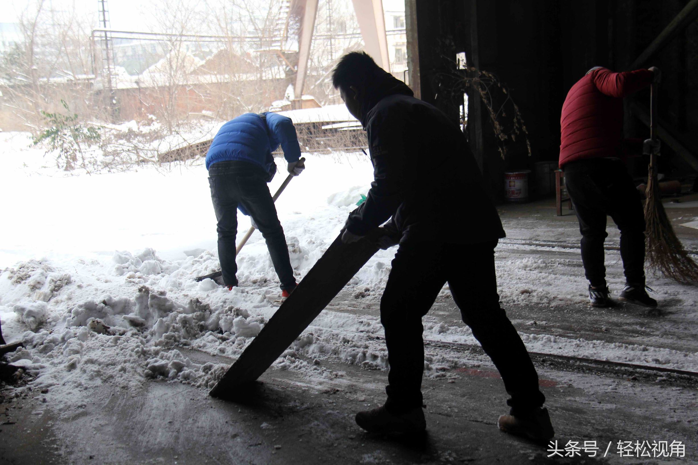 安徽芜湖,今年冬天下了十年一遇的大雪,这些场务工作人员正在将片场中