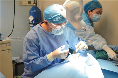 熊靖宇正在为患者做种植牙手术. 资料图片