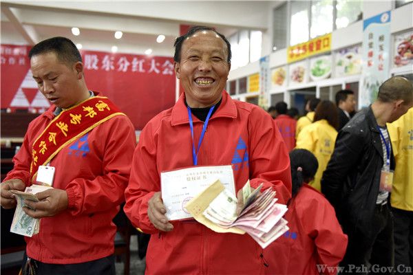 当地贫困户股民陶启刚展示自己的股权证书和分得的红利