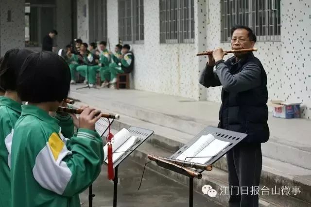 刘英翘向李树芬纪念中学民乐班学生传授吹笛子技巧