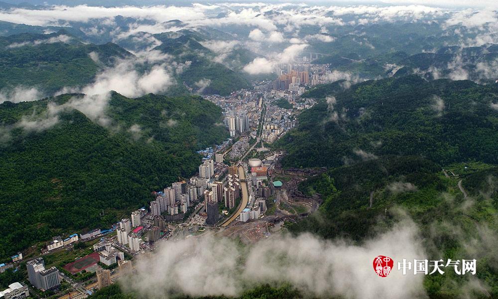 近日,重庆酉阳整个县城被雨雾笼罩,从500米高空上看下去,高楼若隐若