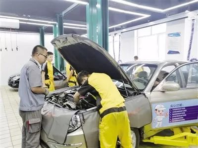 老师指导学生维修汽车