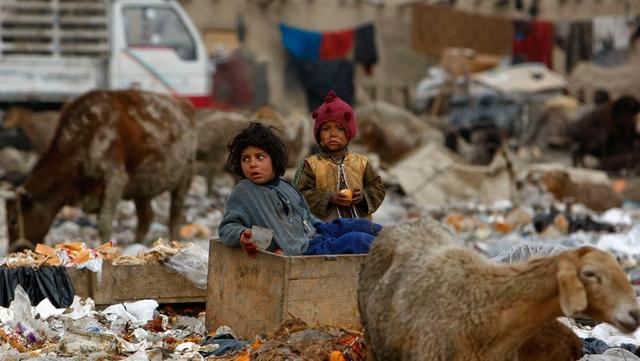 图为生活在垃圾堆中的阿富汗孩子们.