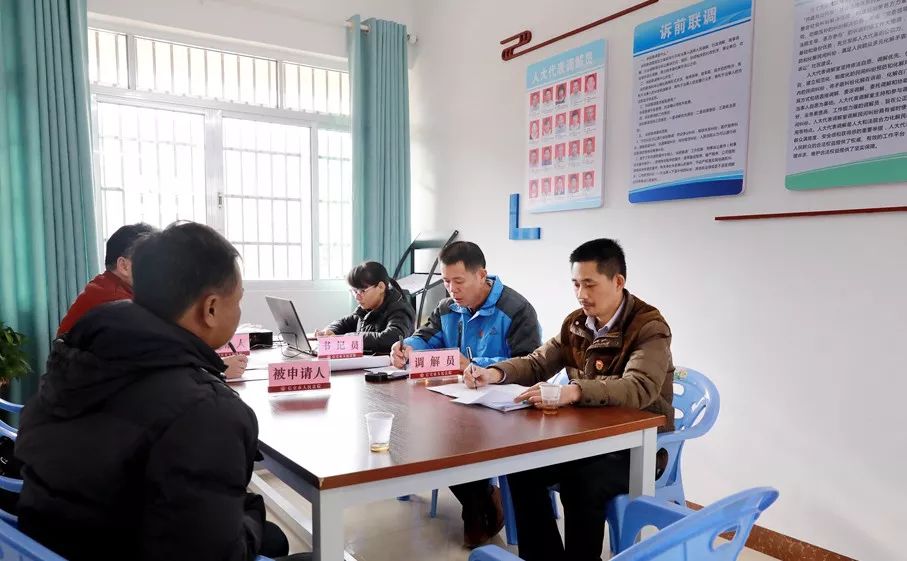 的茂名市人大代表冯朝全和人民调解员谢卫成一起到大坡人大代表调解室