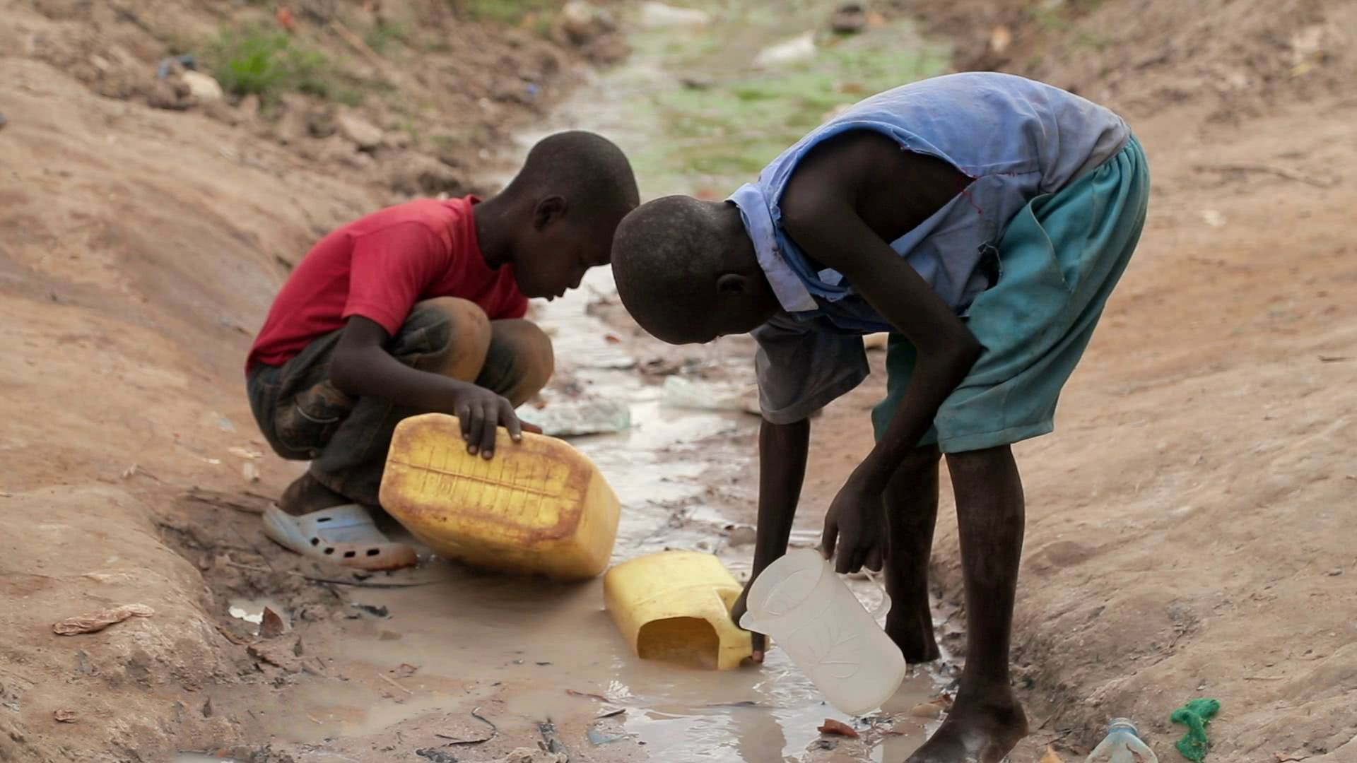 Women carrying water from a bore hole near Oromi IDP camp, in Kitgum ...