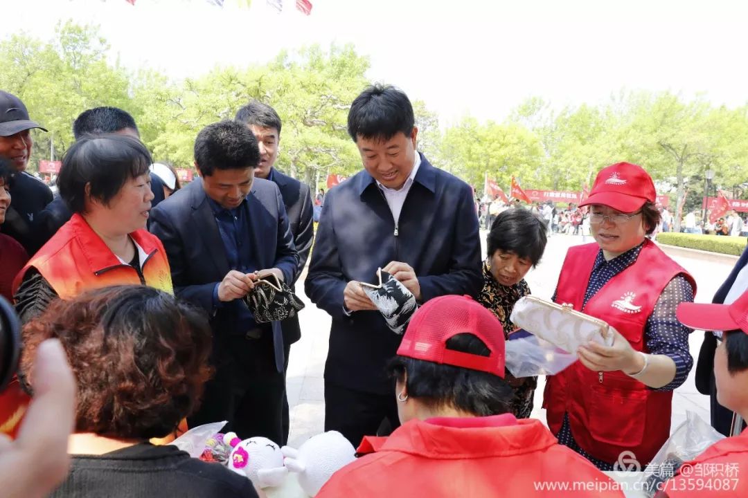 在参观"志愿服务"大集过程中,王洪晓在各个社区的展位前饶有兴趣地