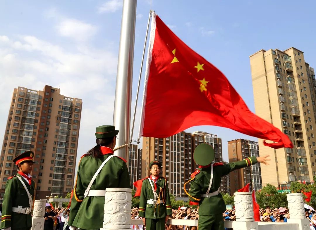 伴随着嘹亮的国歌声,五星红旗冉冉升起,孩子们身姿挺拔,面对国旗行