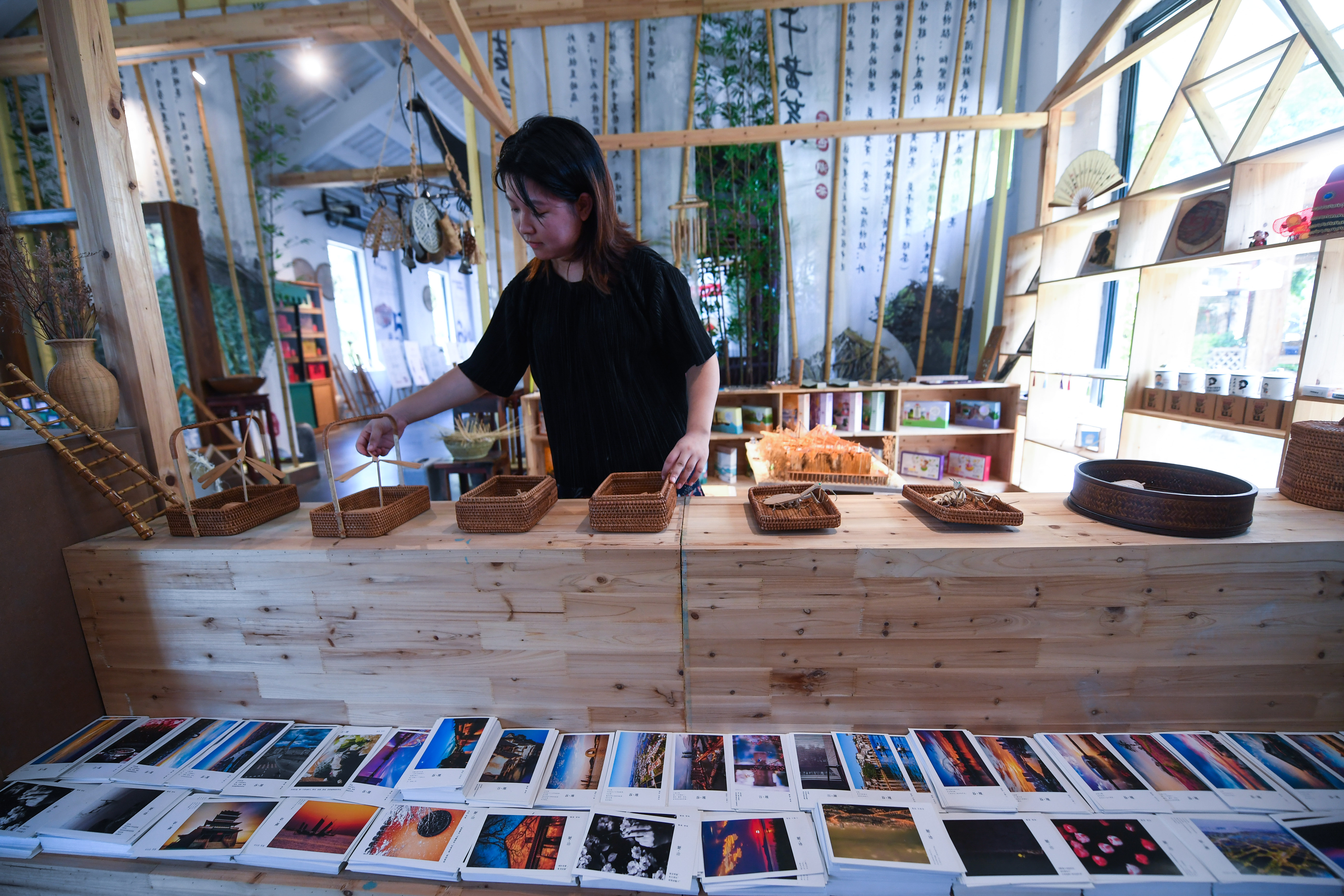 在妙西镇一家乡村小型文化综合体内,工作人员展示特色手工旅游产品