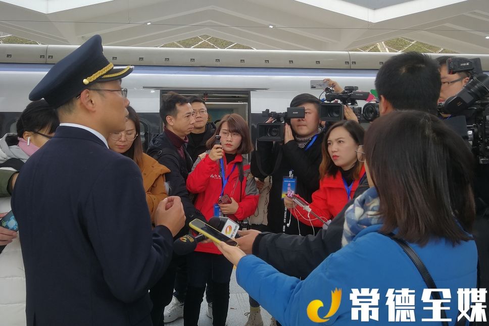 图为张家界车务段站长李芳接受媒体记者采访运行初期的列车到开时刻表