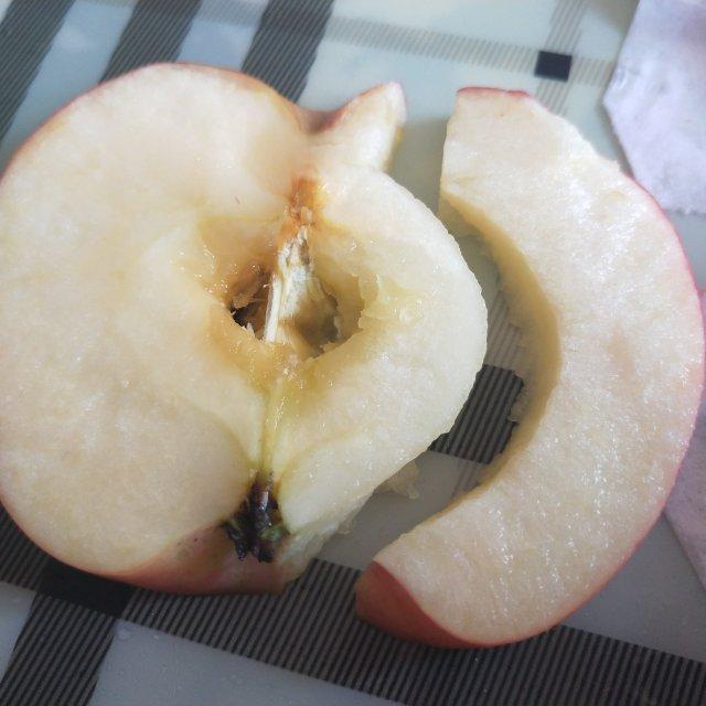 第8步,取剩下的二分之一的苹果,在切面的一侧切下薄厚均匀的一片,按照