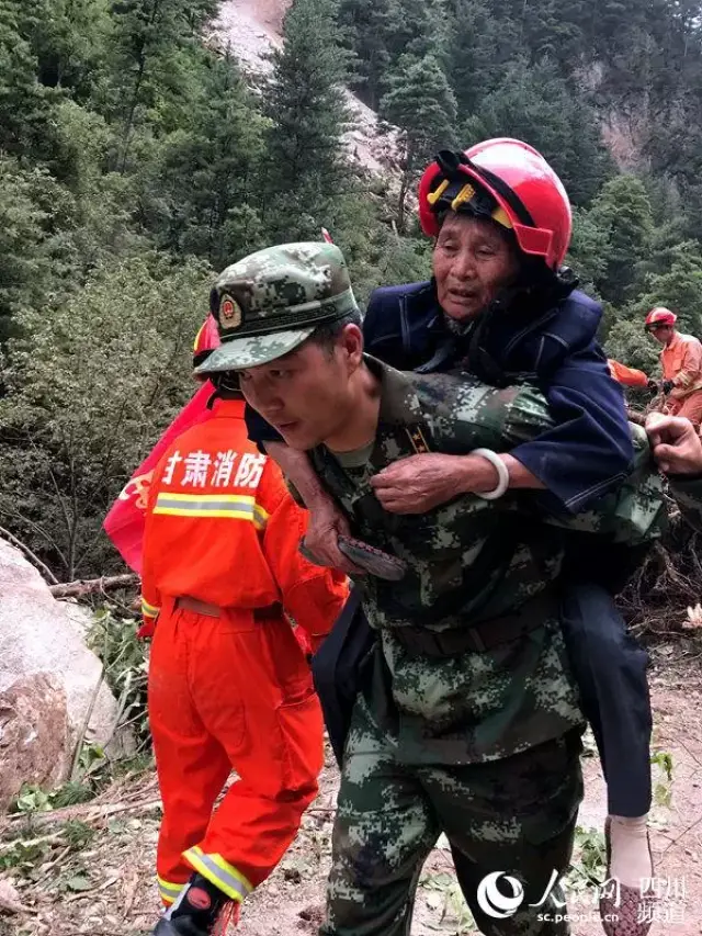 武警水电三总队突击队队员在返程途中,将受伤旅客背出最危险的塌方