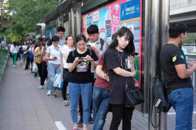 2018年5月25日,北京亮马桥公交车站,下班排队等公交.