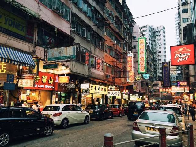 很多消夏的人在热闹的旺角街头走街串巷,头顶闪烁的霓虹招牌层层叠叠