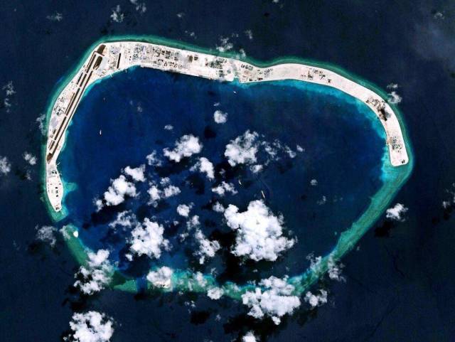 南沙群岛中吹填面积最大的美济礁,目前仍处在建设中,礁盘左侧为机场
