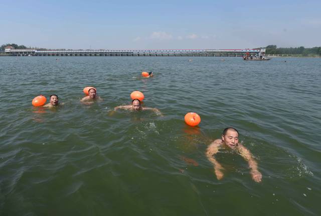 7月15日,游泳爱好者在山东省临沂市郯城县马头镇沂河水面参加畅游赛.