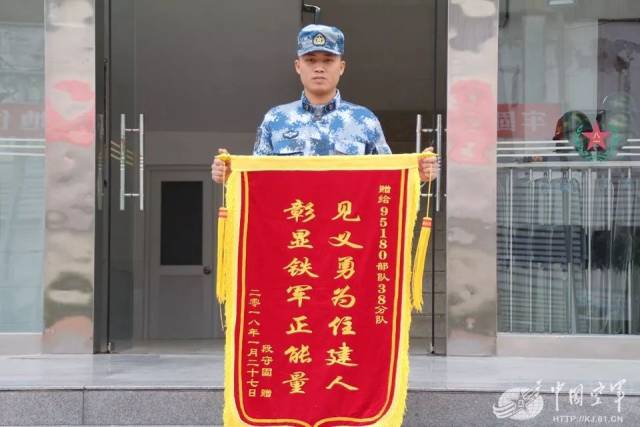 手捧"见义勇为住建人,彰显铁军正能量"的锦旗,来到该队感谢在生命危急