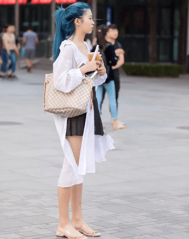 长发及腰的美女,穿着一件牛仔裙,尽显女性风情