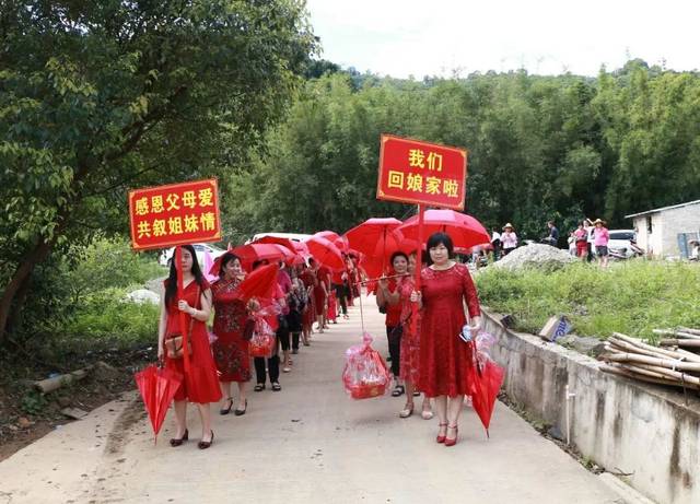 岭背外嫁女回娘家活动隆重而热烈,外嫁女们身穿节日盛装,头上红伞迎