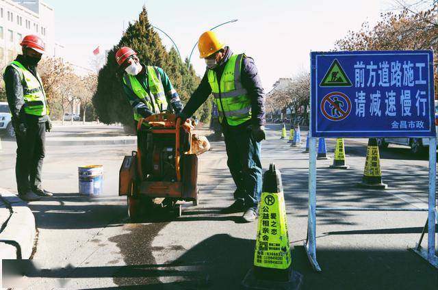 △ 市政工程管理处施工人员在公园路沿线进行道路修补作业.