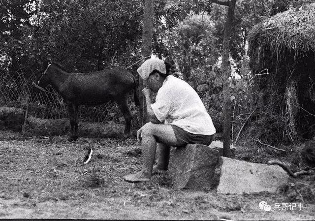 1988年夏天,安徽农村,一位农妇坐在自家院里的草棚前乘凉.