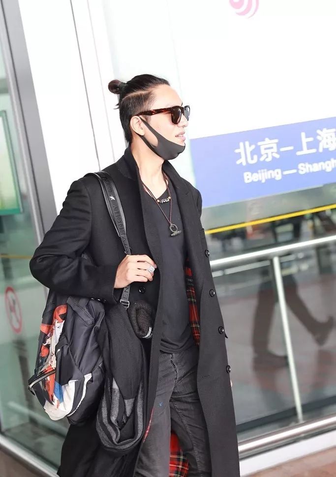 陈坤在北京机场身穿黑色大衣,梳着丸子头露大脑门发型亮眼,比之前短发