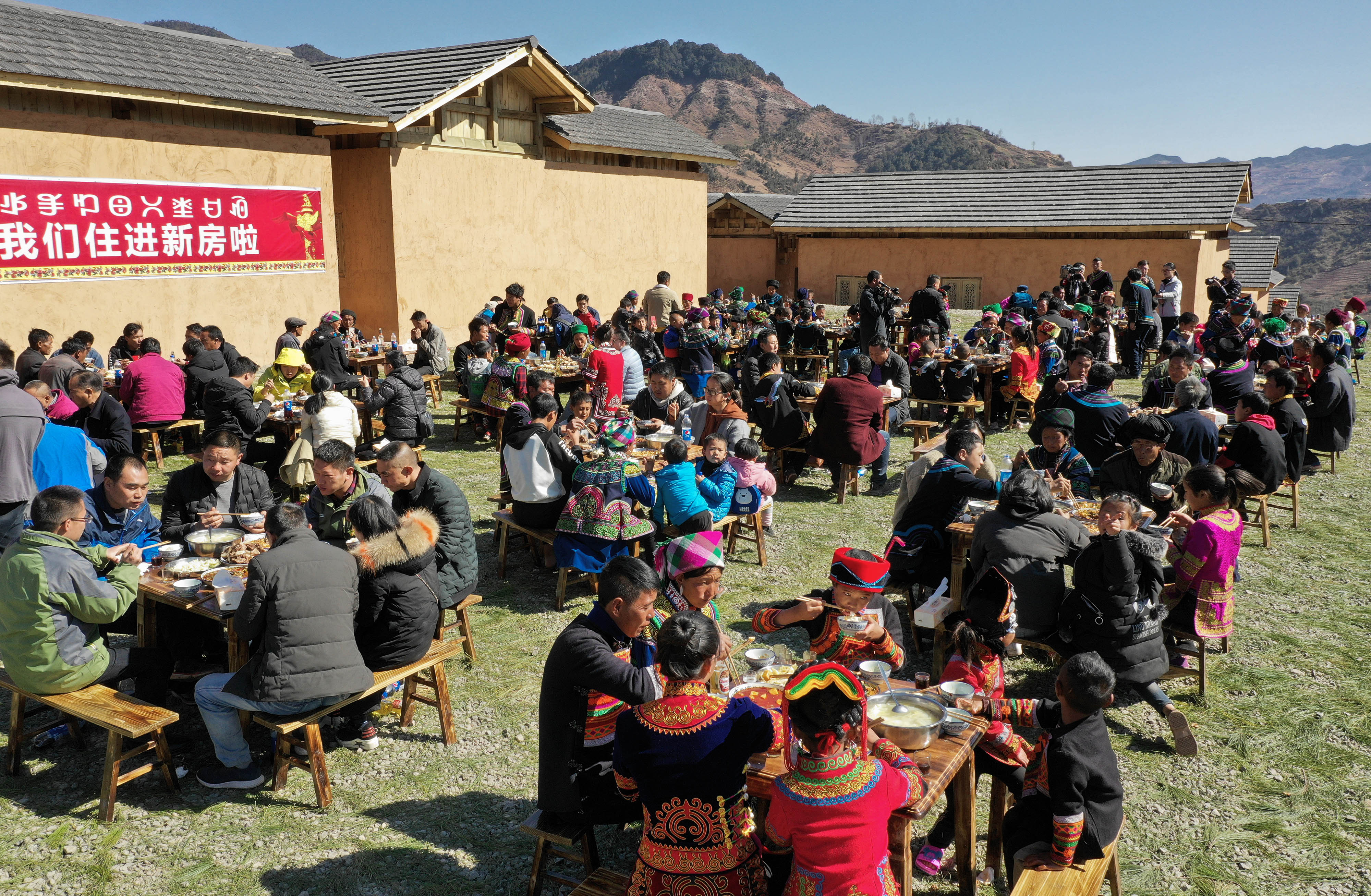 2月11日,在昭觉县三河村的易地扶贫安置点,彝族群众围坐在一起