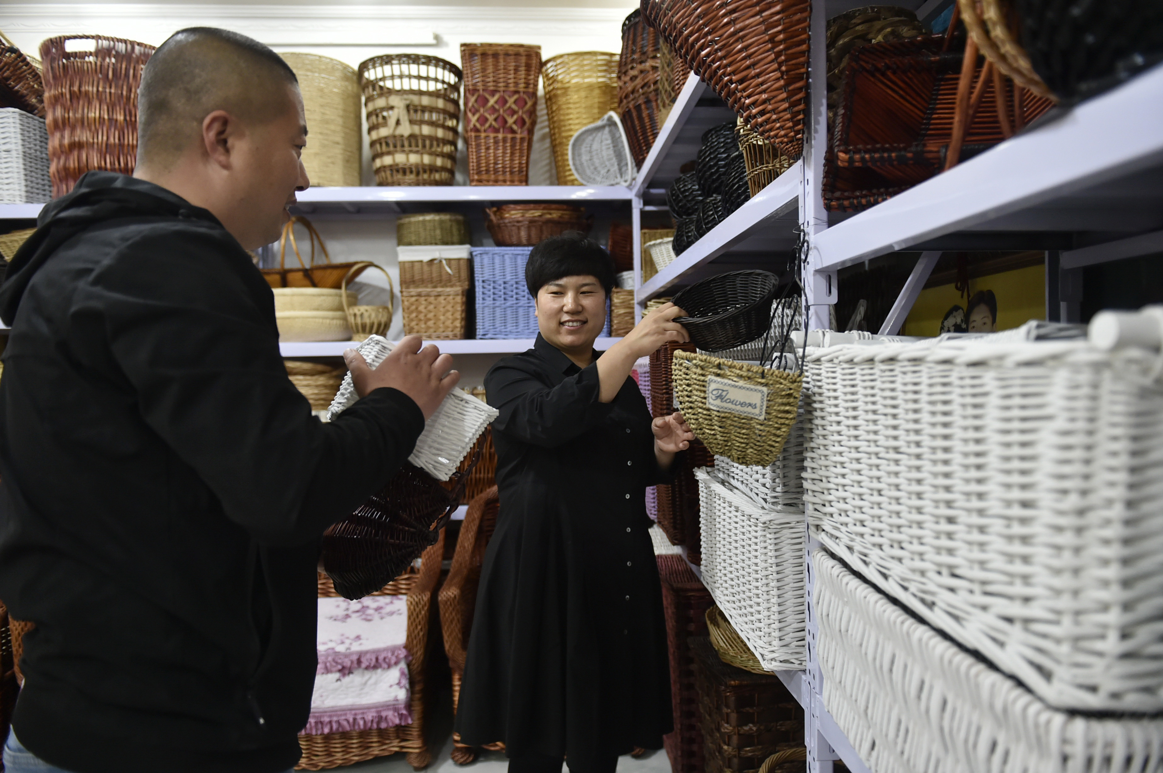 4月24日,在固安縣大孫郭村的柳編工廠產品展示廳,刁新影(右)和丈夫