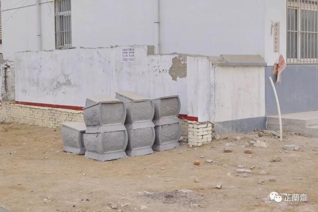 迷你形的水泥棺材碑后为春秋宾馆,是简陋的当代楼面,而碑额的右侧堆在