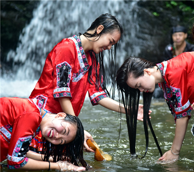 端午节,广东连山壮家姑娘要上金子山洗龙舟水,小伙子在旁边观看_习俗