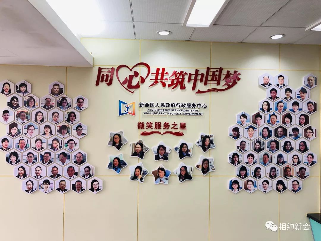 在区行政服务中心政务服务大厅有一幅"微笑墙",墙上展示工作人员的