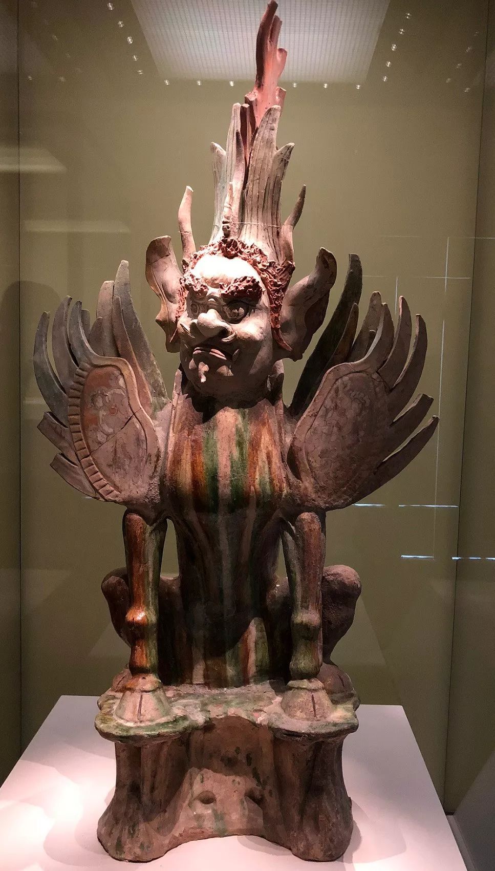 施赭,黄,绿三彩,人面兽身,头生角,耳竖立,头,背竖起火焰形戟,双目圆鼓