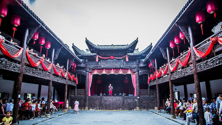 戏台为全松木结构,果柱上雕刻着精美细腻的人物图案.