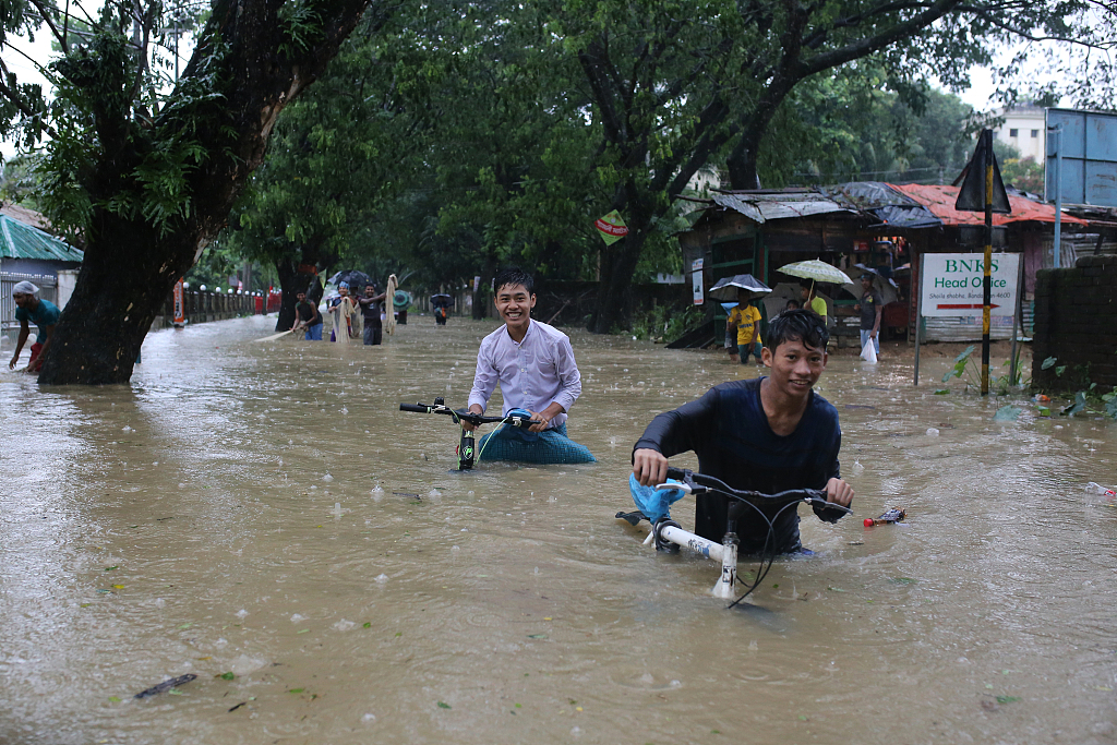 孟加拉国暴雨引发洪涝 民众划船出行