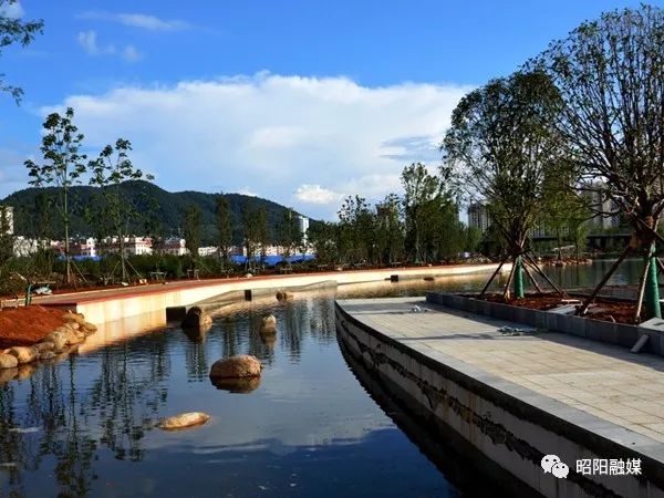 昭通乌蒙水乡公园两个湖区蓄满水,五小门前的桥梁主体工程建设已完工.