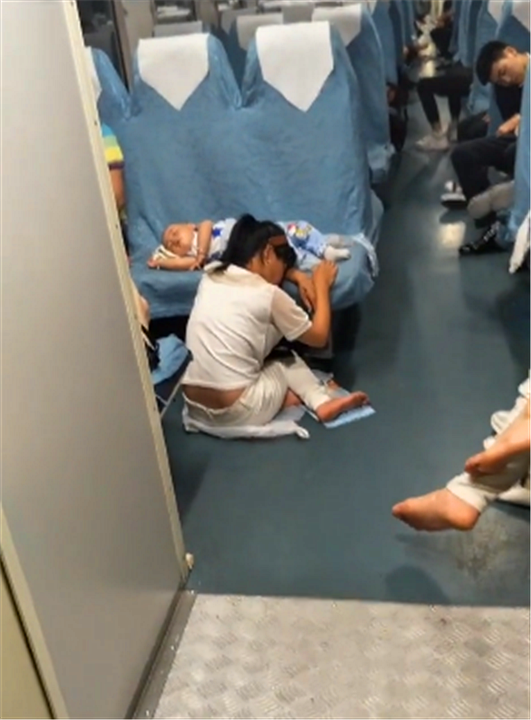 火车上孩子睡着后妈妈趴在地上守护这一幕无数妈妈心酸点赞