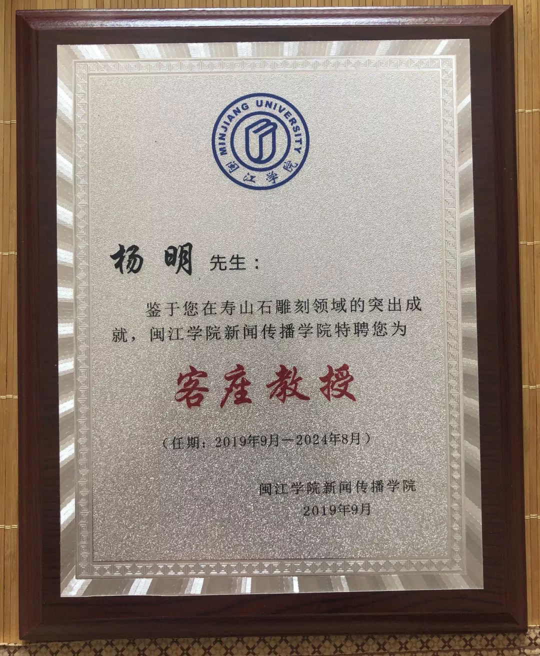 为福建省工艺美术大师杨明先生(左)颁发客座教授聘书闽江学院新闻传播