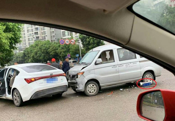面包车和小轿车路口相撞 车牌都撞到后轮下面了_车祸