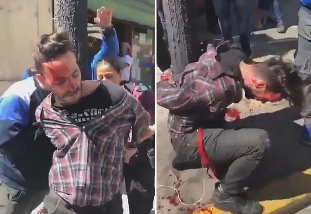 阿根廷一窃贼被捕后绑在灯柱上遭愤怒人群殴打