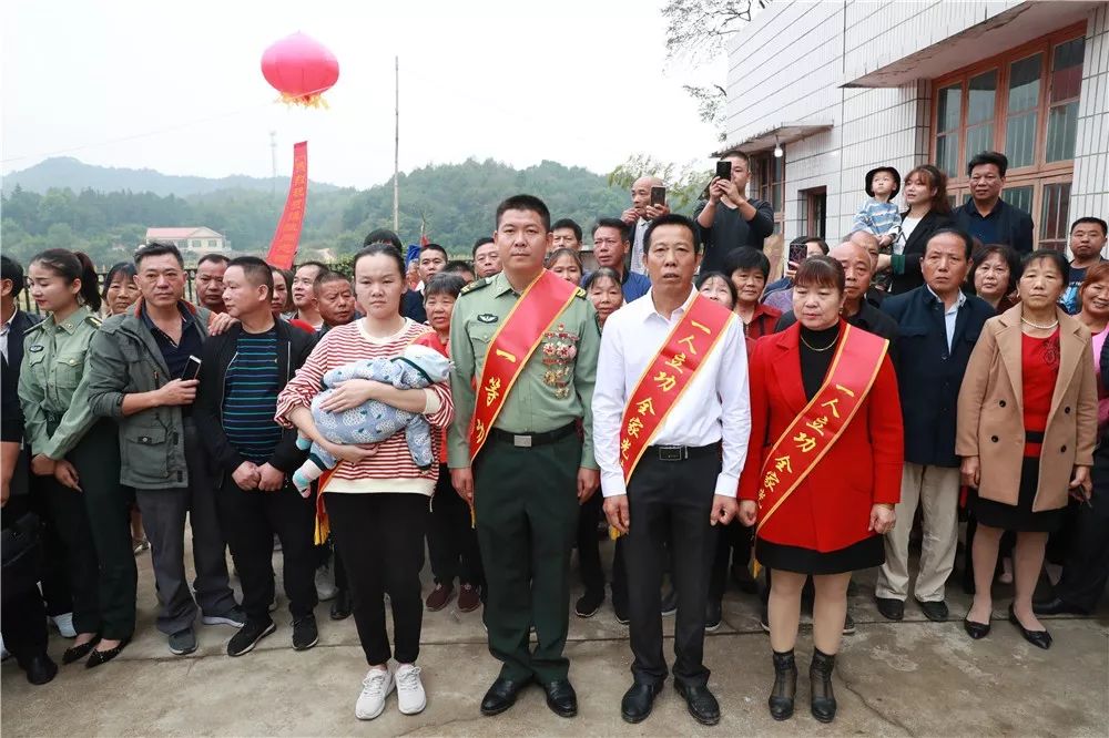 肩披绶带胸戴奖章一等功臣载誉归来军地联合千里送喜报