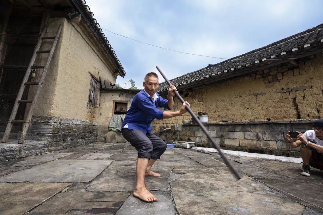 队队长龙长卿的重孙,州级苗族武术传承人67岁的龙正云在表演四门棍