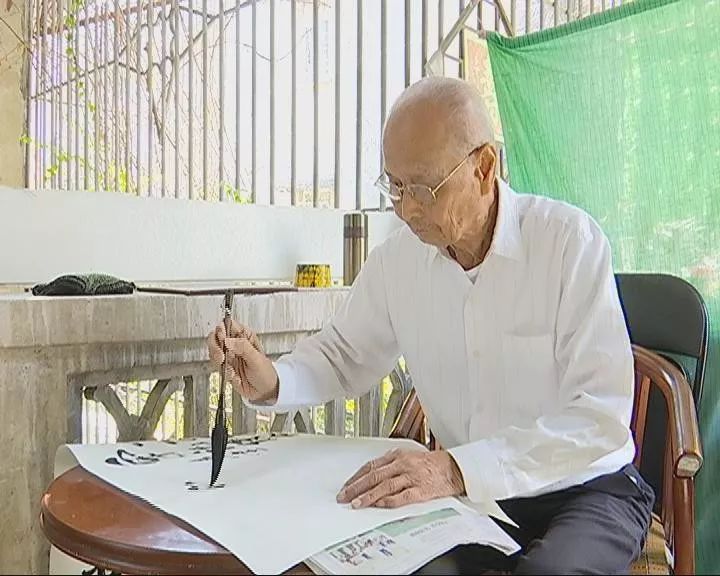 91岁的刘青山正悠然地在自家二楼看书,练习书法