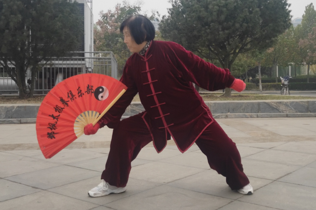 听着精忠报国打着中国太极扇老太太精神头真棒虎虎生风
