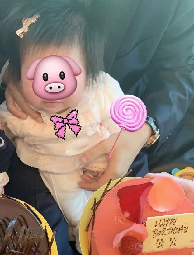 但是可以看出两人都在看镜头,荷包蛋头发特别浓密,穿着粉色婴儿套装