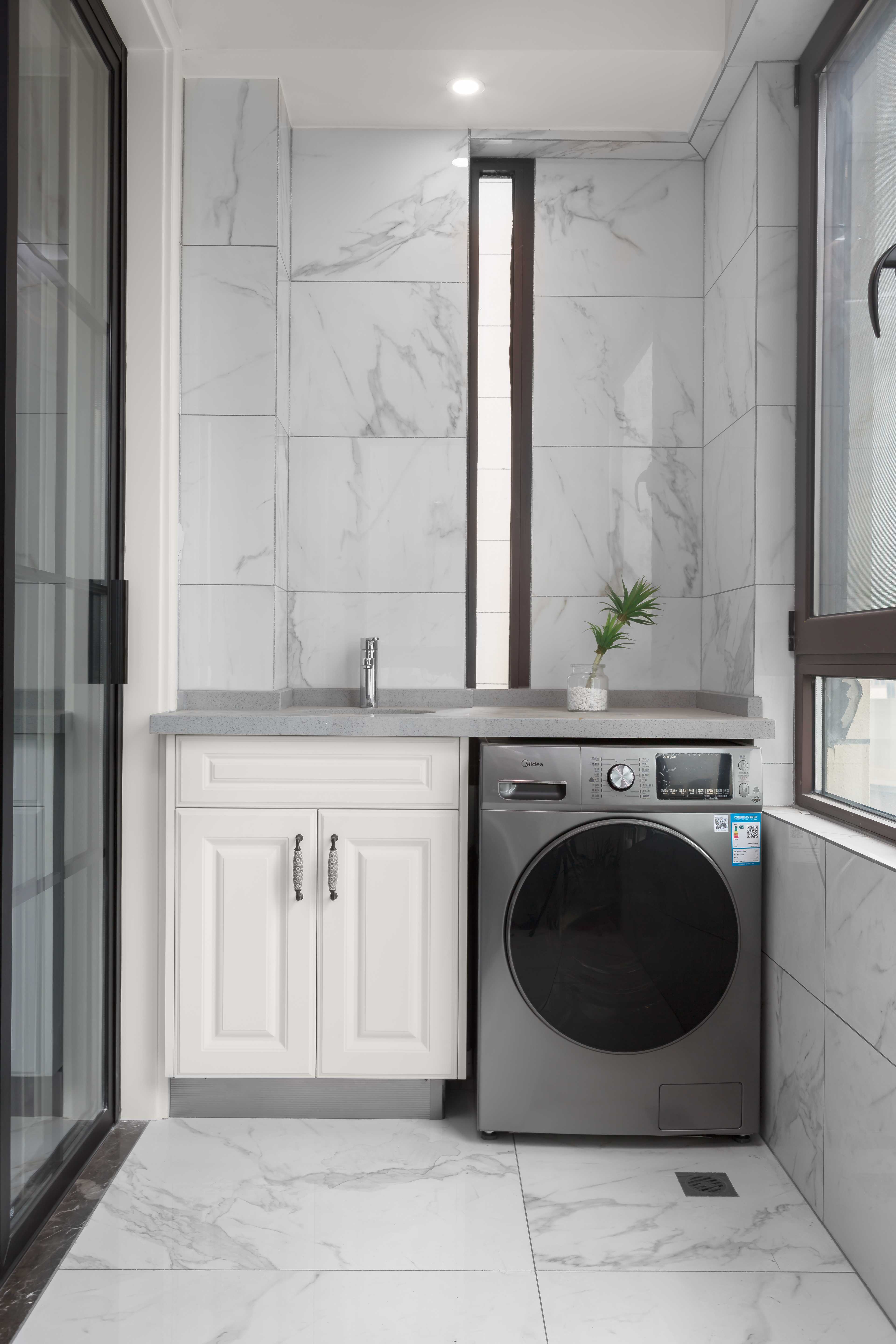 配上定制的洗衣柜灰色台面和灰色洗衣机,使得整个空间变得更加有高级