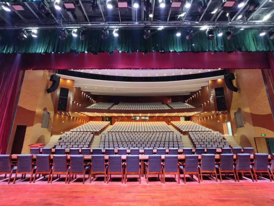 礼堂上纵横密排的灯孔灯光齐明时↓环绕立体声音系统厅内还配备了舞台